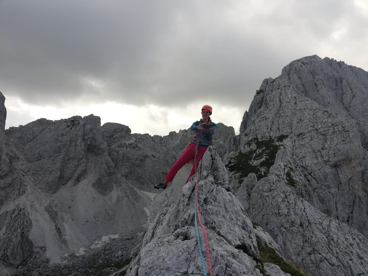 Standing on a mountain ridge summit